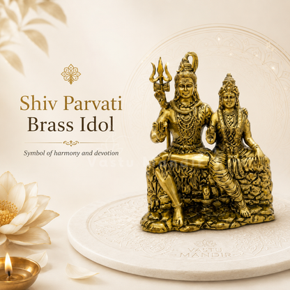 Brass Shiv Parvati idol on a white platform with sacred decorative elements