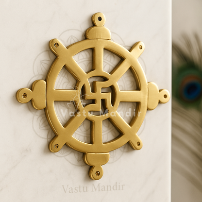 Brass Chakra Satiya Vastu helix symbol displayed on a marble plate in a sacred setting