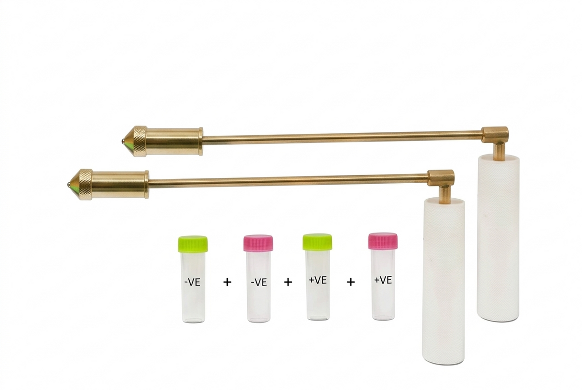 Brass PVC-handled dowsing rods with four labelled sample vials on white