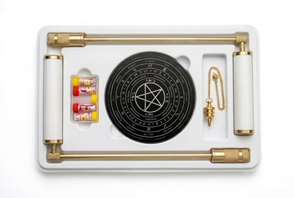 Brass L-rods, pendulum, dowsing board and sample vials in a white case on white