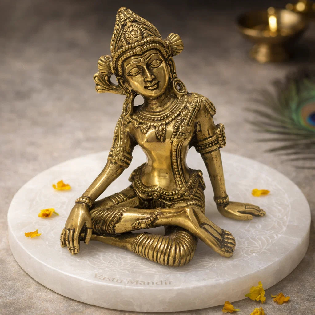 Brass Indra Dev idol seated on a sacred plate with diya and marigold petals