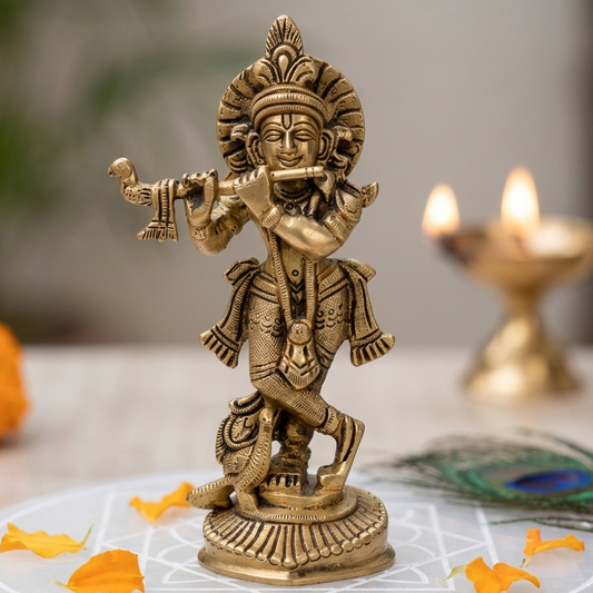 Brass Krishna Ji idol playing the flute on a sacred plate with floral accents