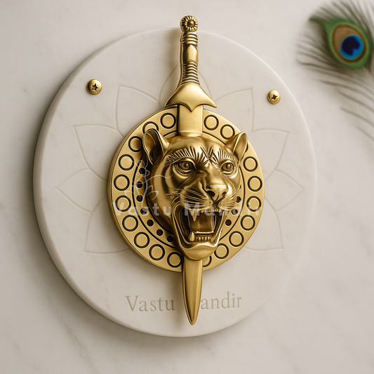 Brass lion face with removable talwar mounted on a white marble backing plate with peacock feather