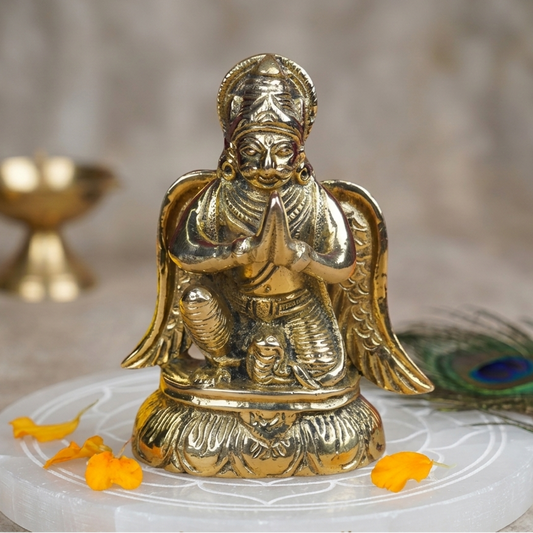 Brass Lord Garud Dev Ji idol seated on a sacred white plate with floral accents