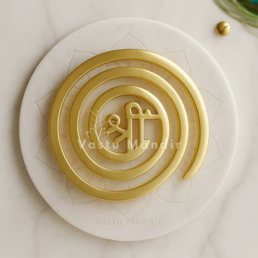 Brass Shree Vastu spiral helix displayed on a marble plate