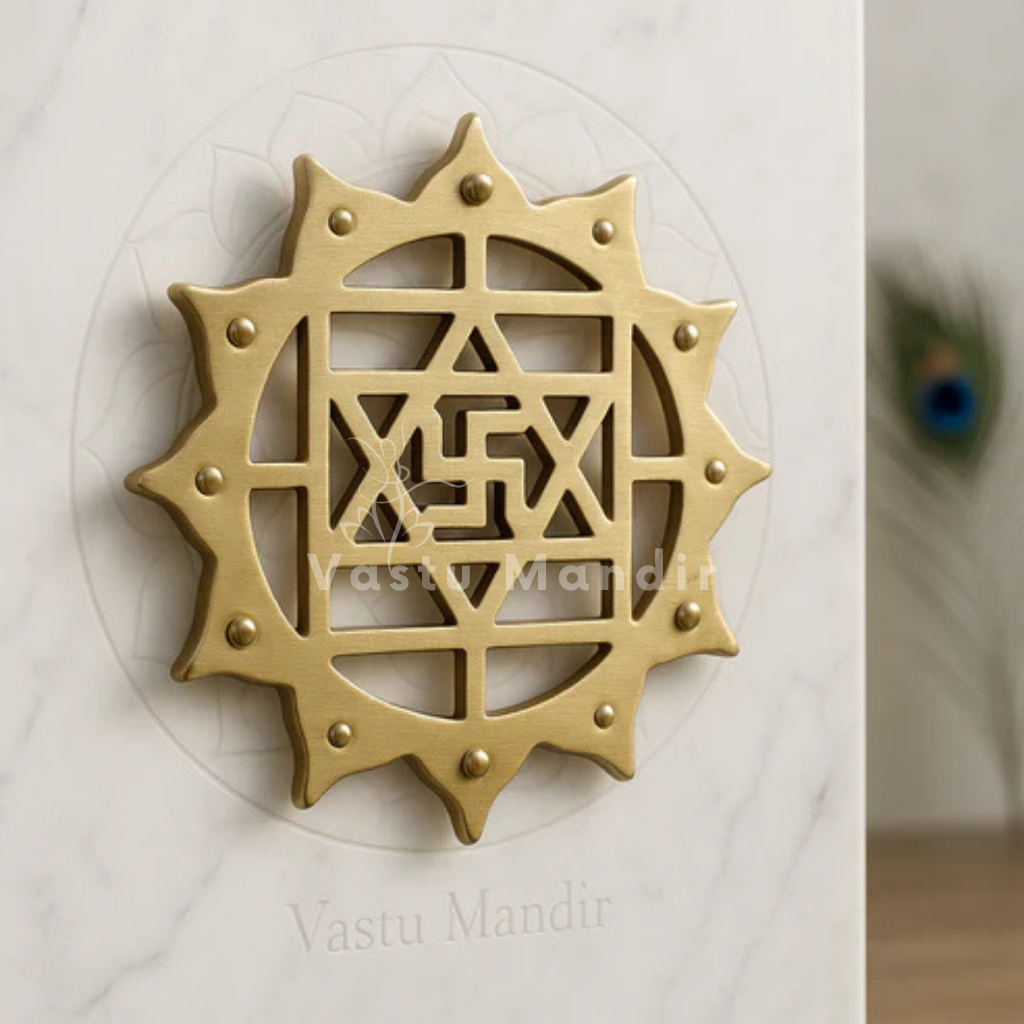Brass Kamal Satiya Vastu wall symbol displayed on a marble plate in a sacred setting