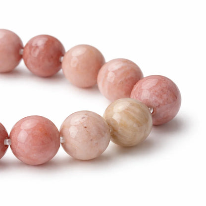 Close-up of natural rhodochrosite bracelet showing soft pink bead patterns