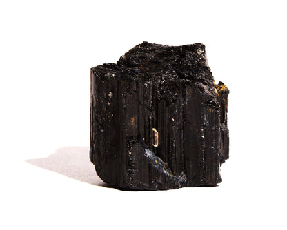 Single striated black tourmaline piece isolated on a clean white background