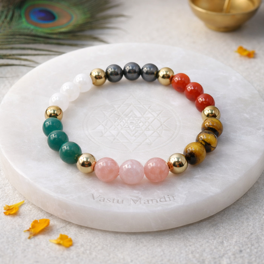 Dhan Vriddhi Crystal Bracelet displayed on a round stone plate with marigold petals