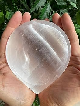 Diya Selenite Charging Bowl in a hand