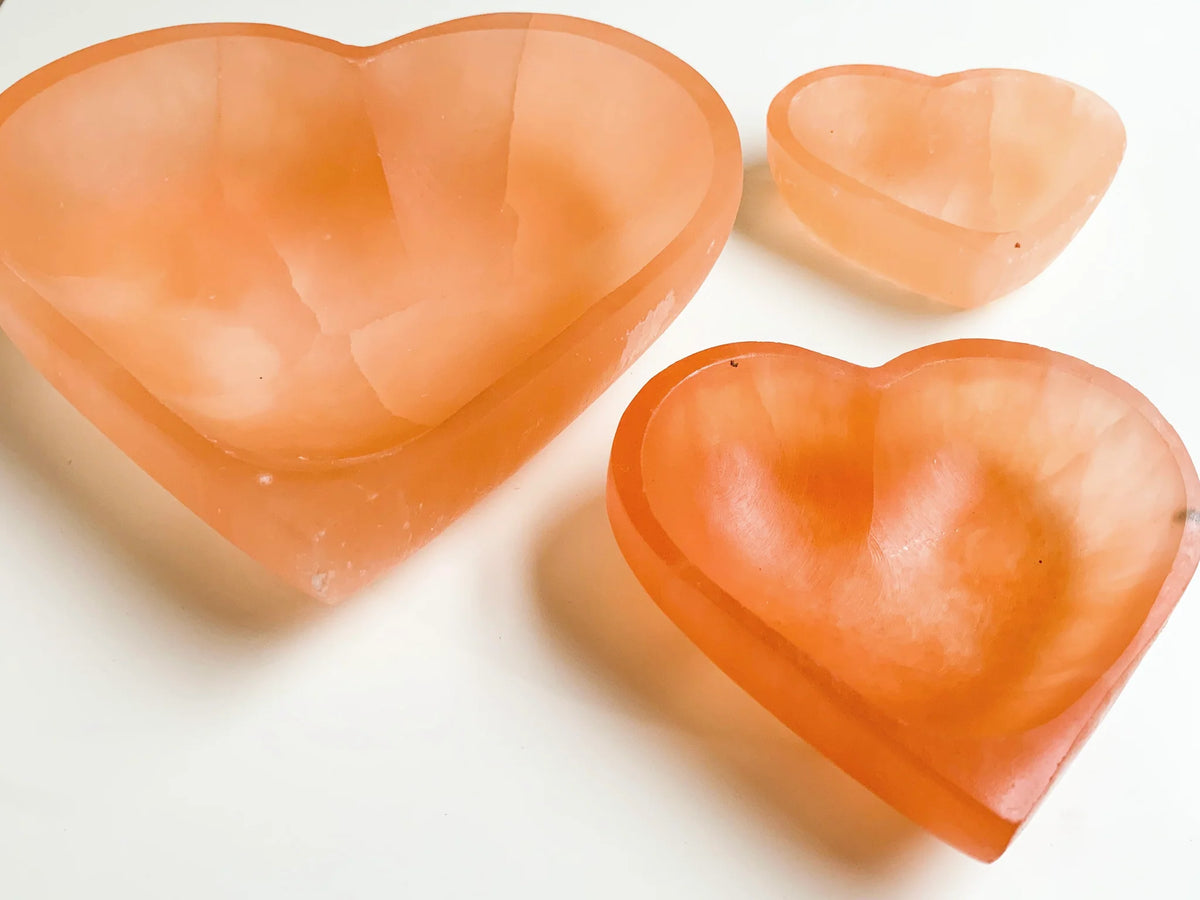Orange heart selenite charging bowl in another clear product photograph