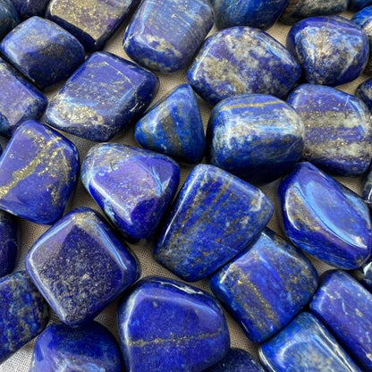 Macro view of blocky lapis lazuli stones showing deep blue colour and gold flecks