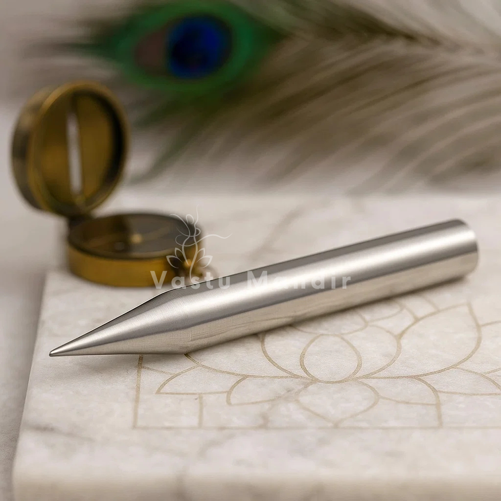Iron Vastu Kilak rods on a marble surface with a peacock feather in the background