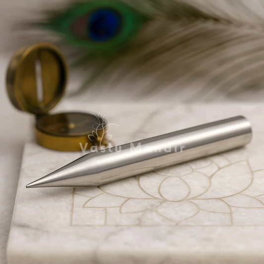 Iron Vastu Kilak rods on a marble surface with a peacock feather in the background