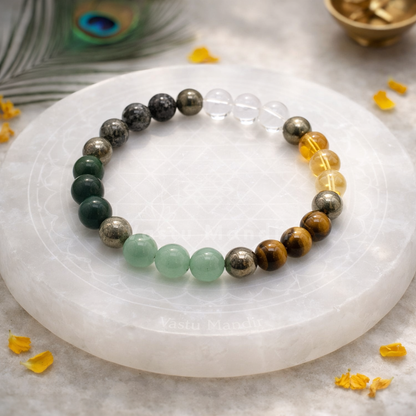 Money Magnet Bracelet — 8mm Beads on a white stone surface with peacock feathers and yellow flowers.