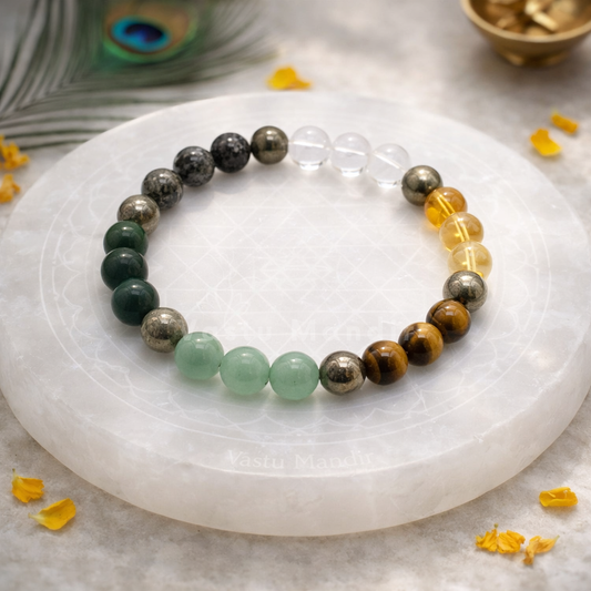 Money Magnet Bracelet — 8mm Beads on a white stone surface with peacock feathers and yellow flowers.