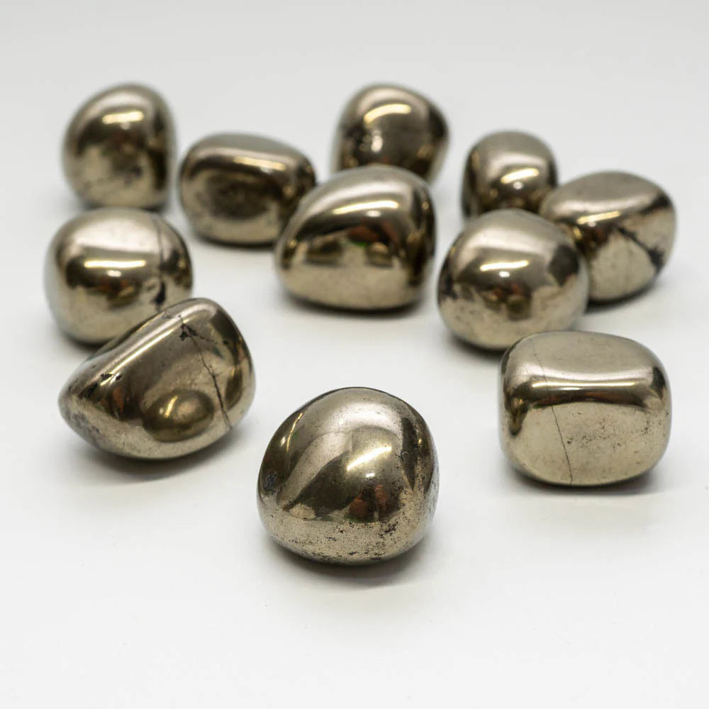 Rounded metallic pyrite stones grouped on a clean white background