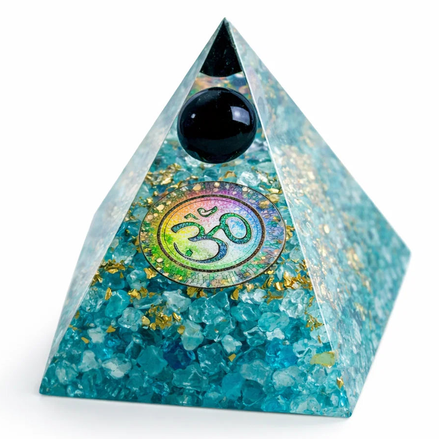 Turquoise pyramid crystal with black sphere and Om symbol on a white background