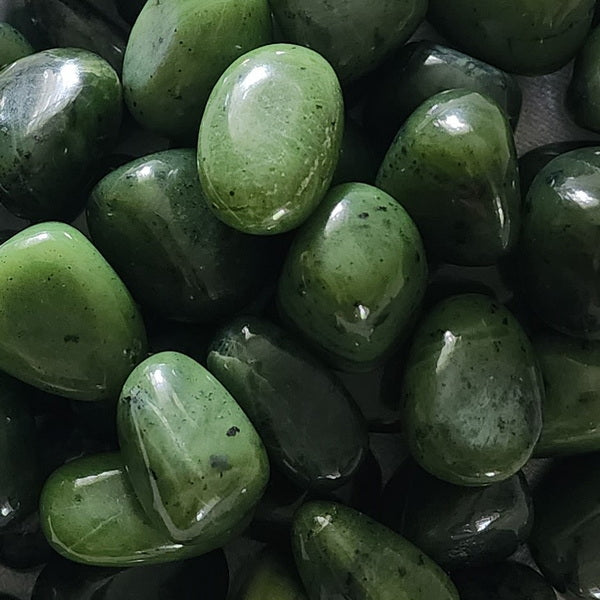 Tight macro view of olive green jade stones showing rounded polished forms