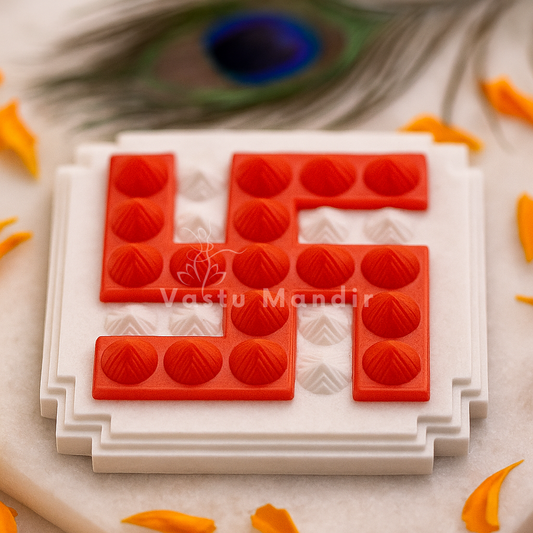 Red plastic pyramid swastik with a white base design on a neutral background with peacock feathers.