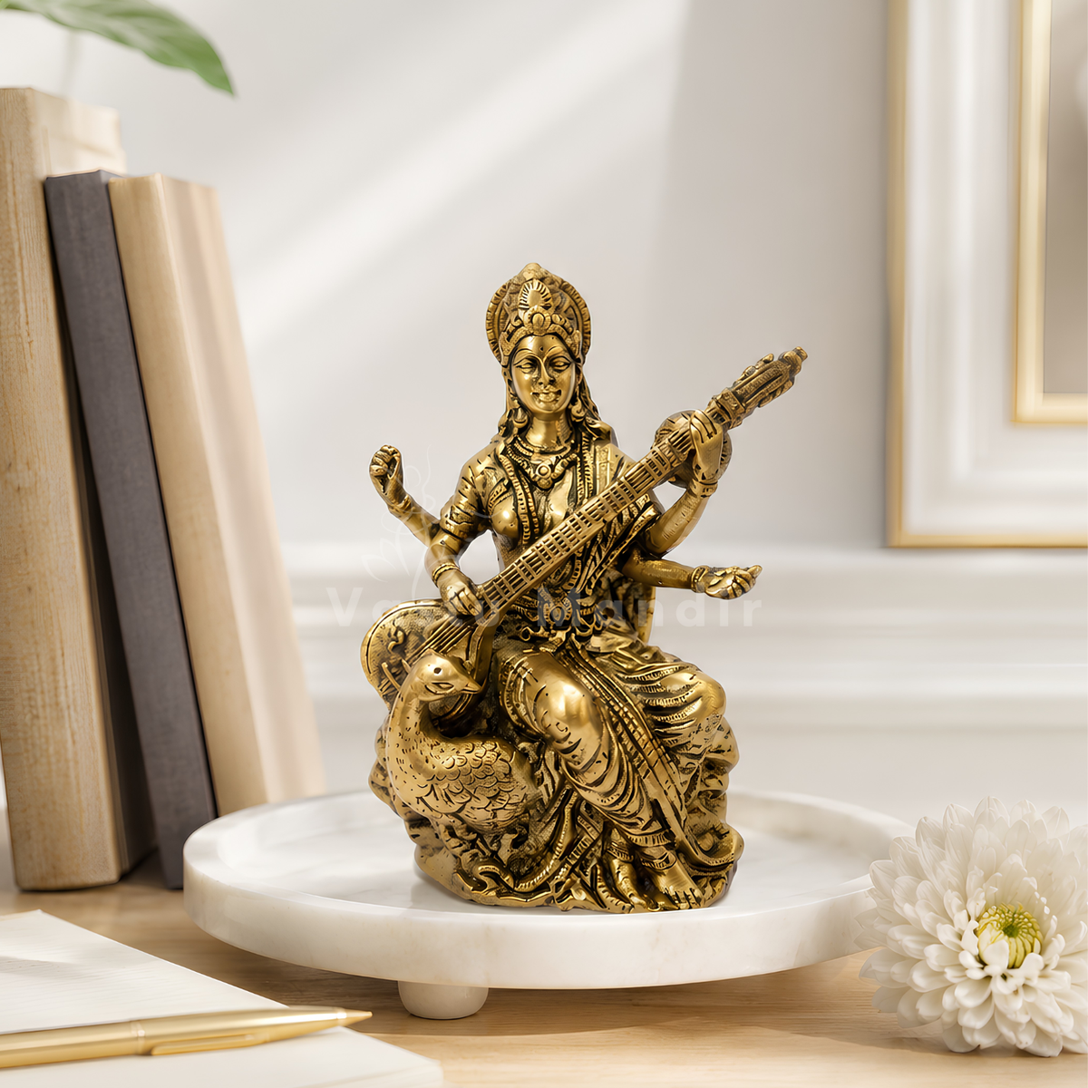 Saraswati Ji brass idol left-side view isolated on white background