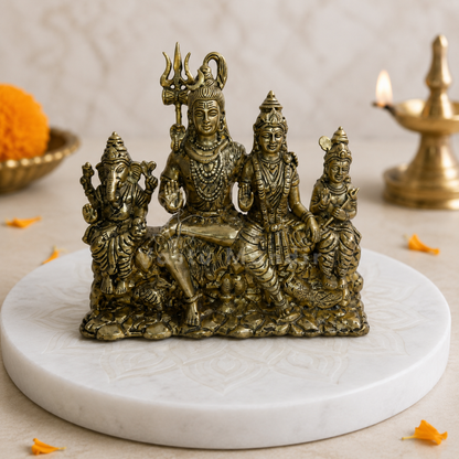 Shiv Parivar brass idol front view on a sacred white pedestal with floral accents
