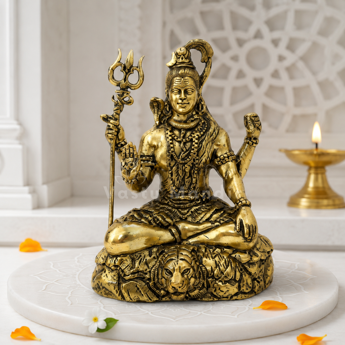 Brass Lord Shiv Ji idol front view on a sacred white platform with floral accents