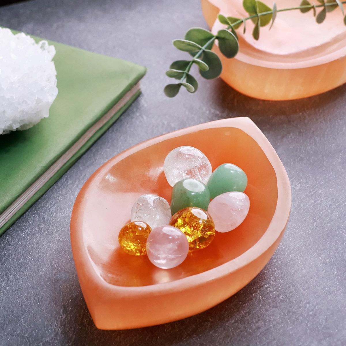 Orange divyya selenite charging bowl arranged in a styled spiritual setting