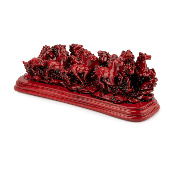 Twelve red running horses resin sculpture on a white background, front three-quarter view