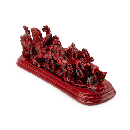 Twelve red running horses resin sculpture on a white background, left three-quarter view