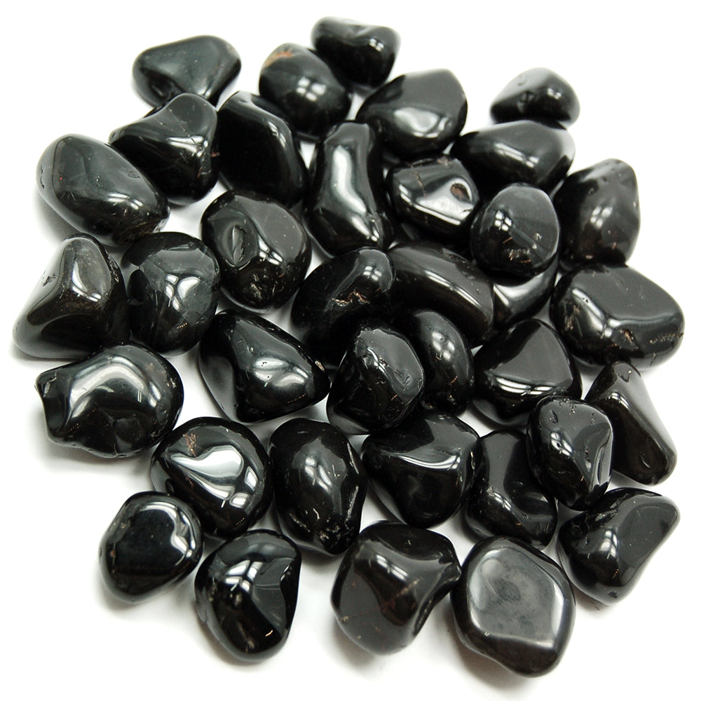 Pile of polished black onyx stones isolated on a clean white background