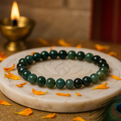 Natural moss agate crystal bracelet shown with a hand in a lifestyle photograph