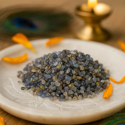 Angled close view of mixed blue-grey sapphire chips on a decorated white plate