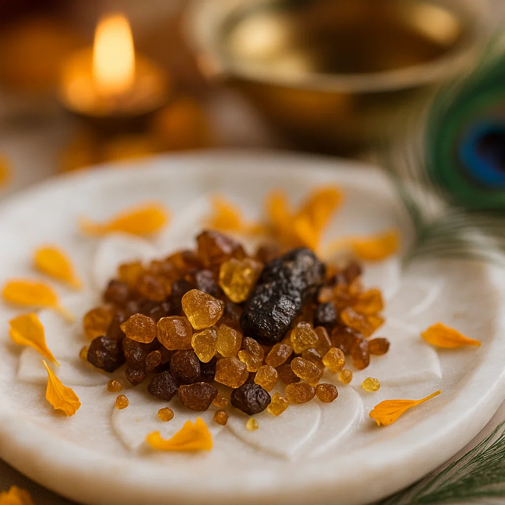 Angled close view of mixed amber hessonite chips on a white plate with marigold petals