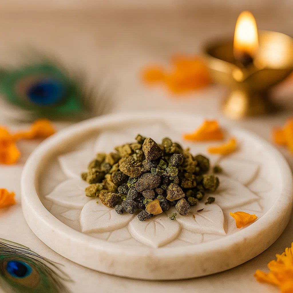 Small rough green gemstone chips arranged on a white plate with marigold petals