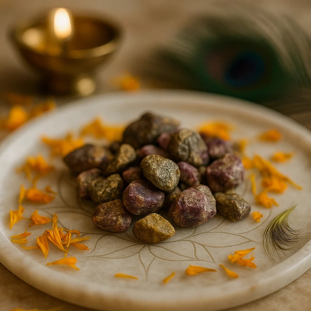 Rough ruby zoisite stones displayed on a white plate with marigold petals and brass decor