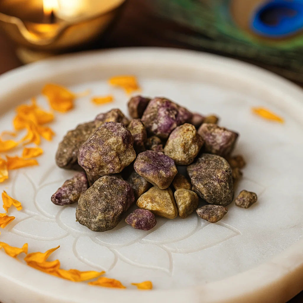 Close view of green and purple rough ruby zoisite stones on a decorated white plate