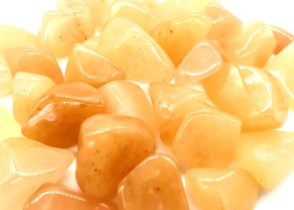Macro view of orange-yellow jade stones showing glossy polished surfaces