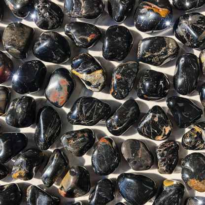 Close-up of translucent black onyx stones showing reflective polished surfaces