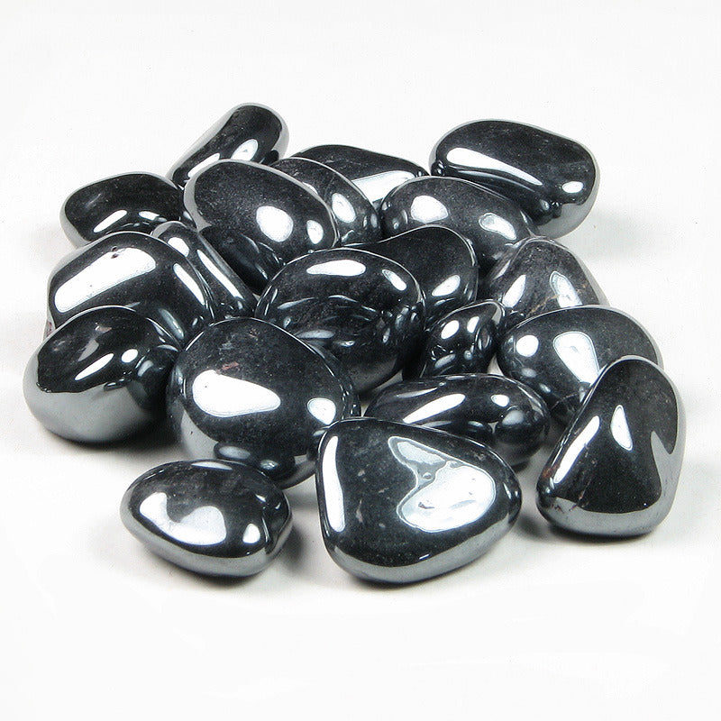 Polished hematite tumbled stones grouped on a clean white background