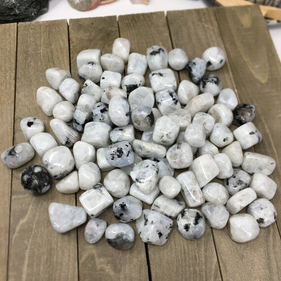 Pile of small blocky moonstone pieces on a wooden surface