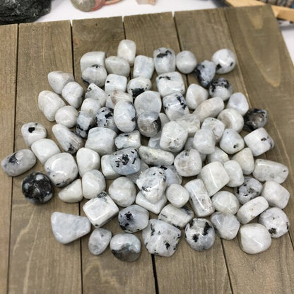 Pile of small blocky moonstone pieces on a wooden surface