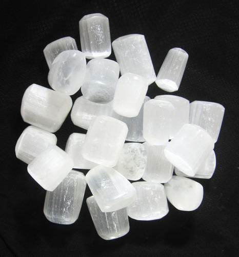 Mixed selenite rods, cubes and irregular pieces isolated on white