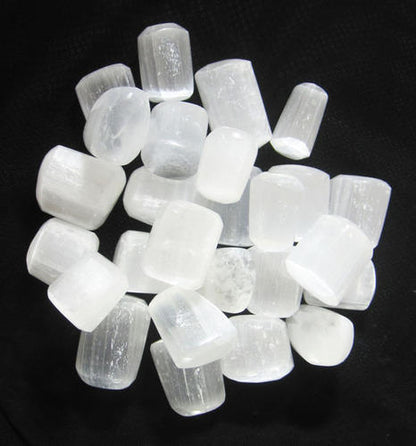 Mixed selenite rods, cubes and irregular pieces isolated on white