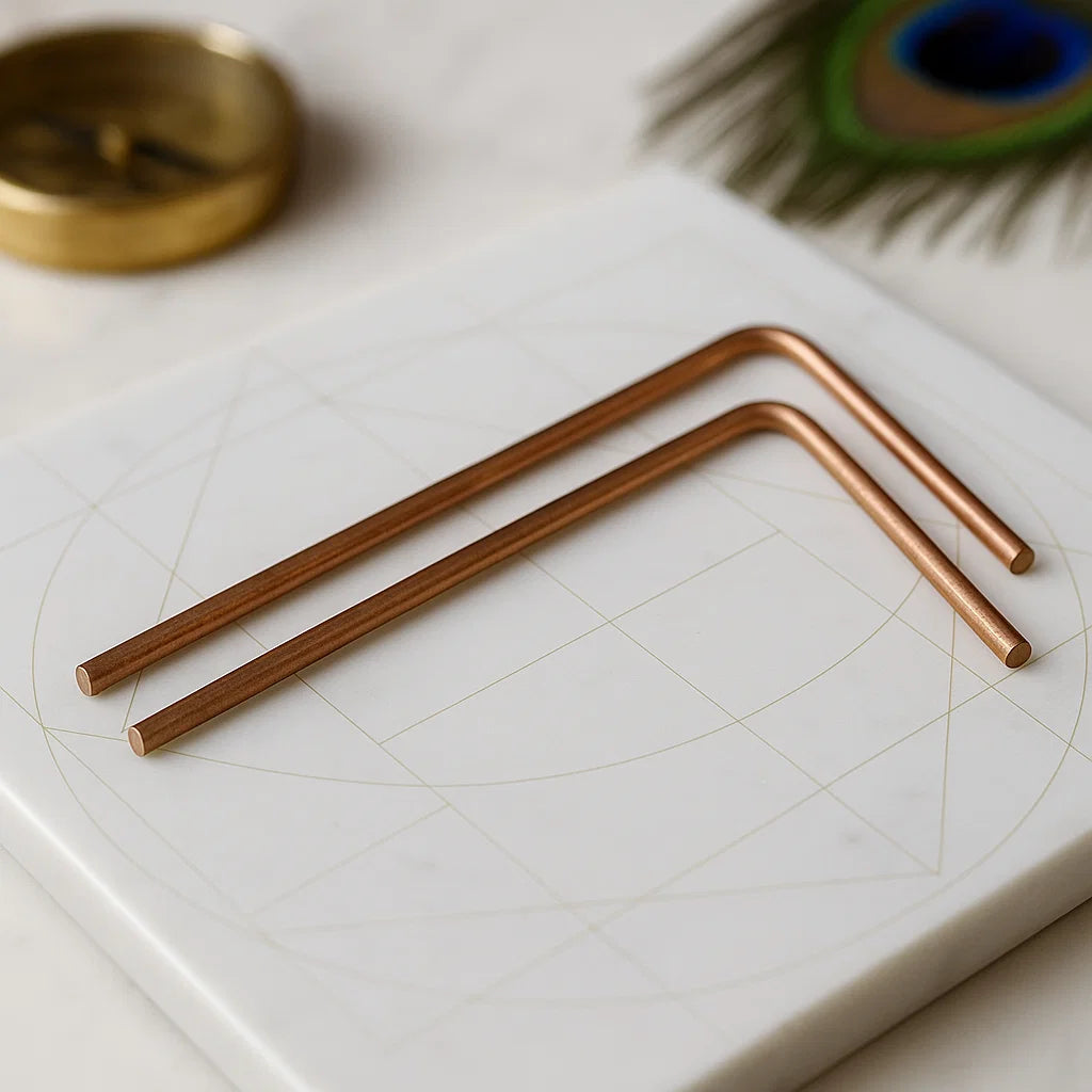 Plain copper dowsing rod pair displayed in a light sacred setting