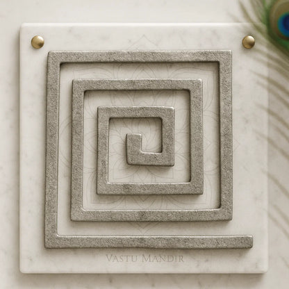 Lead Plain Vastu helix in a square spiral form displayed on a marble panel in a sacred setting