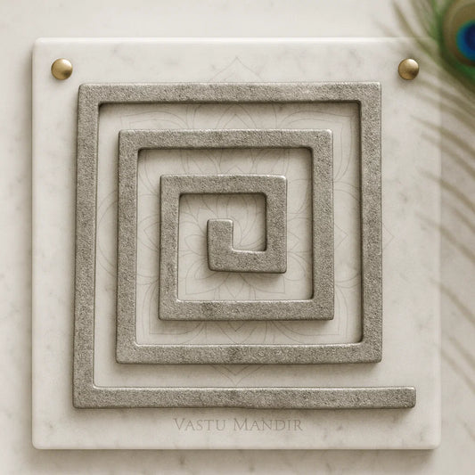 Lead Plain Vastu helix in a square spiral form displayed on a marble panel in a sacred setting