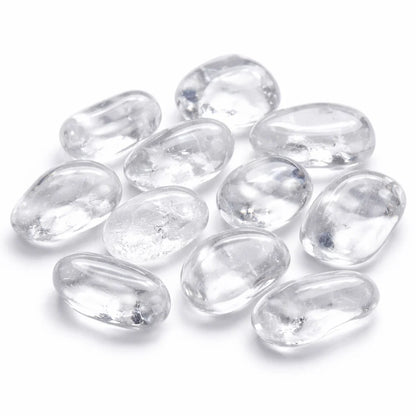 Large clear quartz tumbled stones grouped on a clean white background