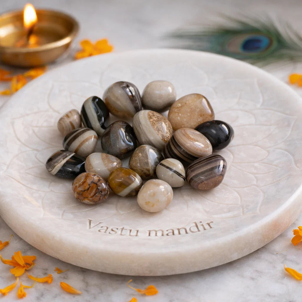 Natural sulemani hakik tumbled stones arranged on a decorative display surface