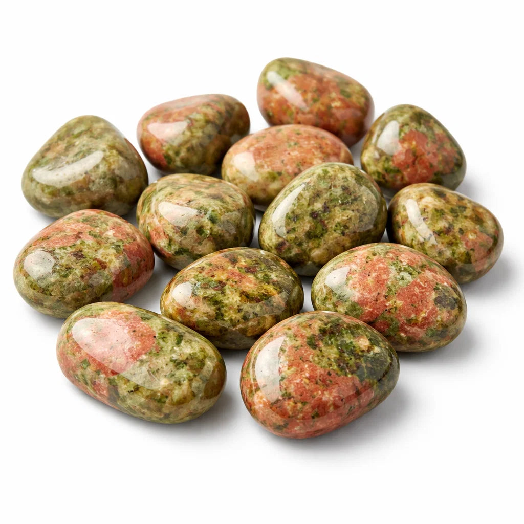 Close-up of unakite tumbled stones on a clean white background showing natural colour and texture